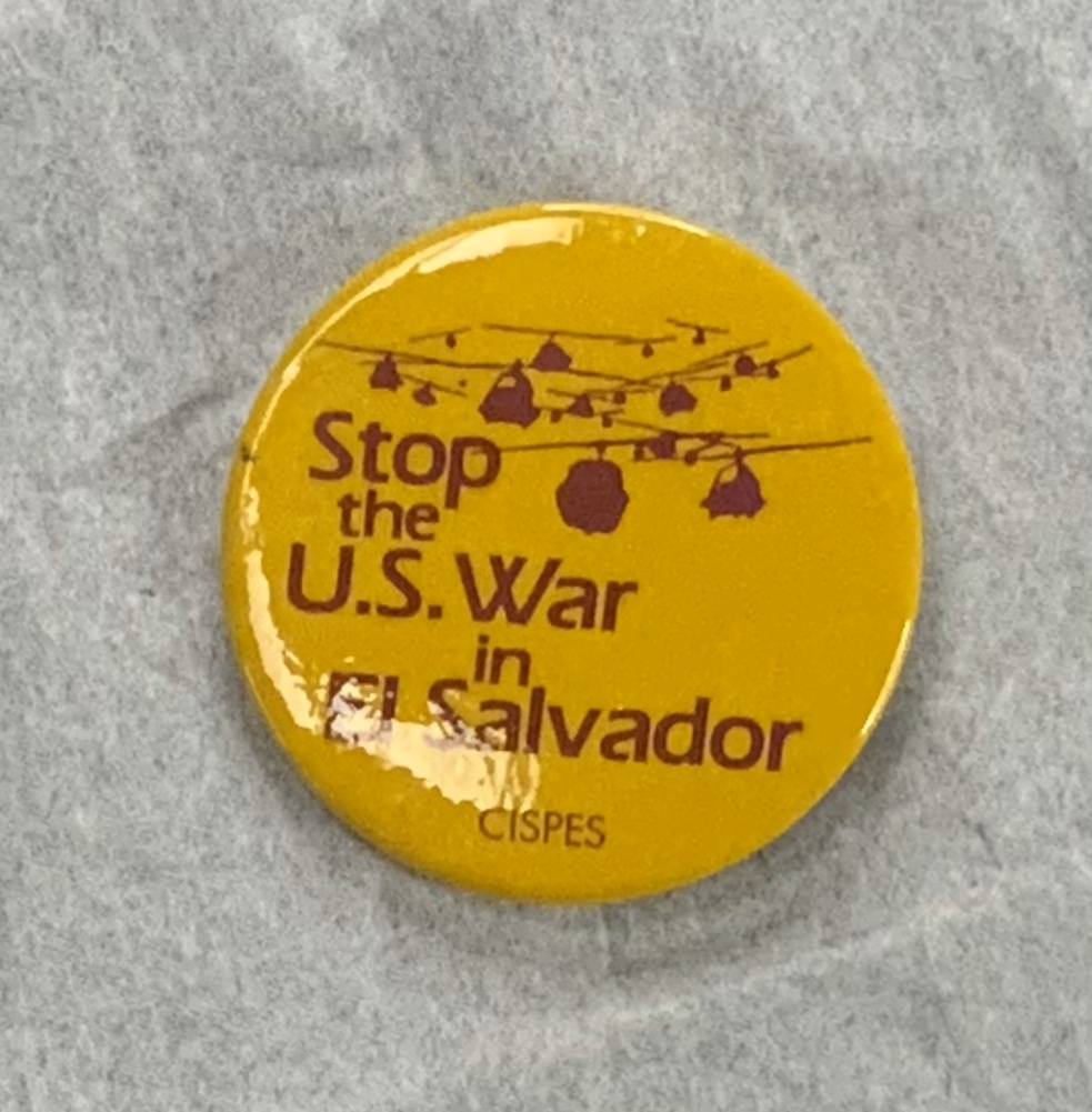 Pin against US support for wars in South America. From the Griot Museum of Black History, Alice Windom Collection.