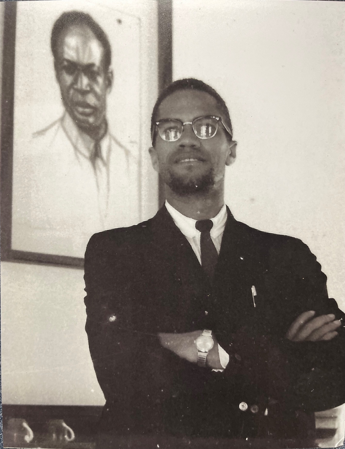Malcolm X in front of portrait of Nkrumah
