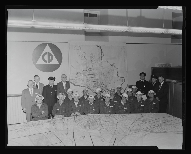 Historic image of Civil Defense employees in an office.