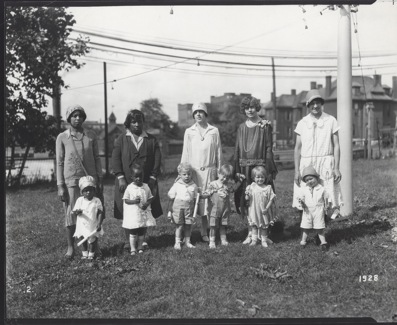 Mothers and Children After Ceremony. Four Children Are Holding Rolled Certificates