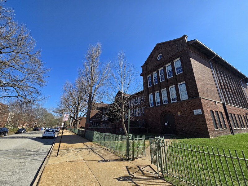 Wide view of the front and side of the Sigel School building.
