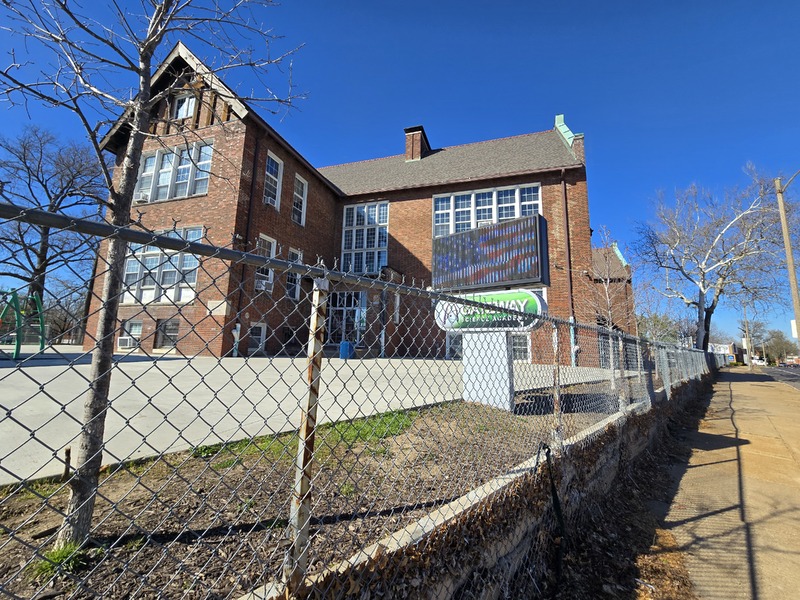 View of Gardenview School building behind a fence, showing main sign for Gateway Science Academy.