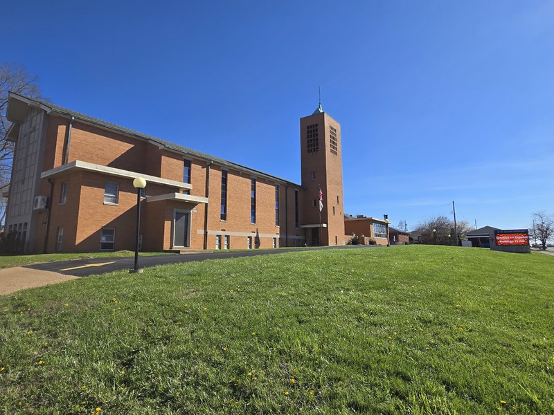Wide view of St. Lucas church building and lawn.