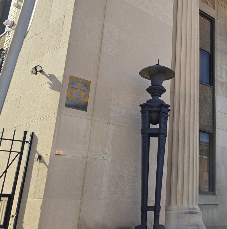 Close up view of a fallout shelter sign on the Bremen Bank building.