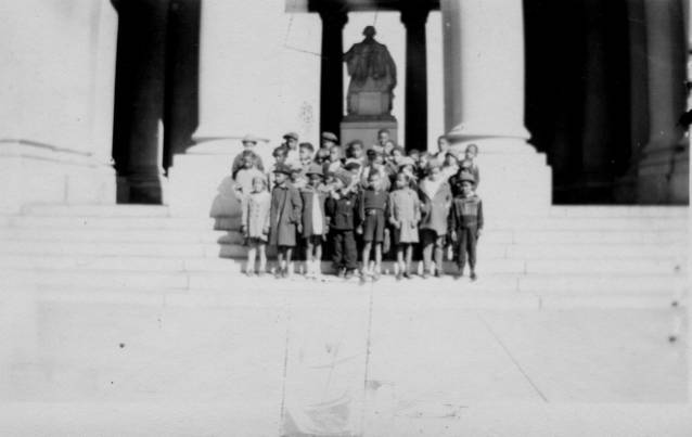Children Standing at Monument during Field Trip