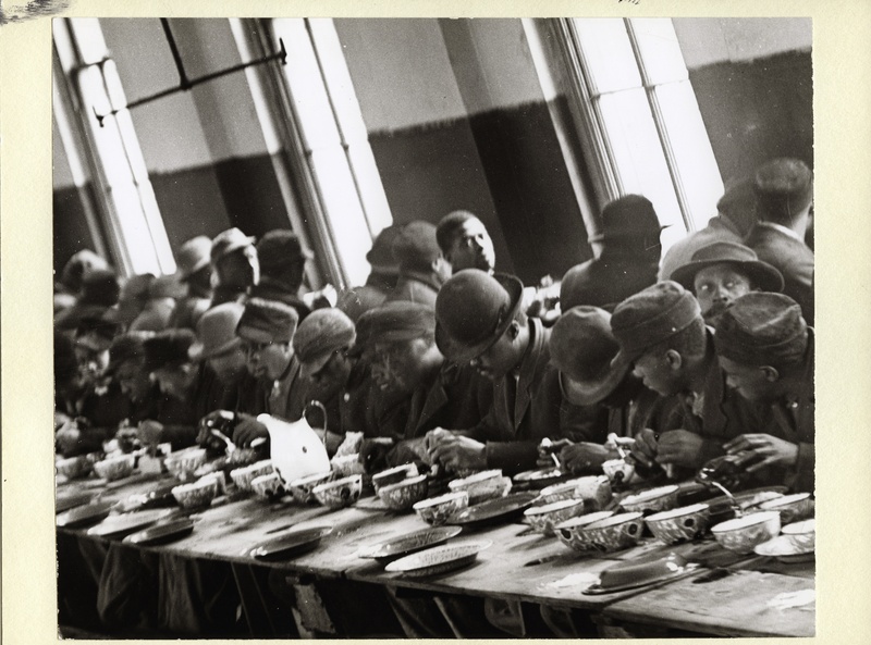 African American Men Eating at a Soup Kitchen