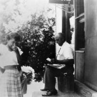 Charles Thomas and His Daughter Alice in Front of His Grocery Store