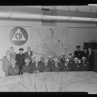 Historic image of Civil Defense employees in an office.