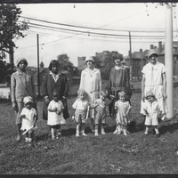 MOTHERS AND CHILDREN AFTER CEREMONY. FOUR CHILDREN ARE HOLDING ROLLED CERTIFICATES