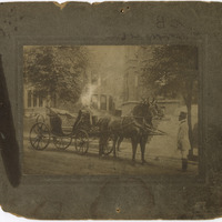 AFRICAN AMERICAN MAN, PROBABLY GREEN HUNTER, POSING WITH A TEAM OF HORSES HITCHED TO A CARRIAGE