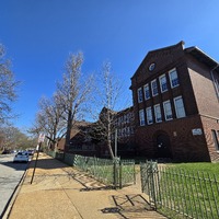 Wide view of the front and side of the Sigel School building.
