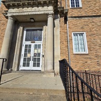 View of Woerner School building front entryway and cornerstone.