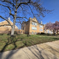 Wide view of the front and side of the Woerner School building.