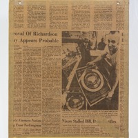 Section of news stories on the back of a map cut from a newspaper.