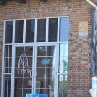 Close up view of fallout shelter sign by an entryway to the Gardenville School building.