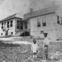 Two Unidentified Young Boys in Front of Douglass School