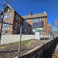 View of Gardenview School building behind a fence, showing main sign for Gateway Science Academy.