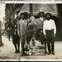 AFRICAN AMERICAN MEN AND BOYS WITH FOURTH LIBERTY LOAN SIGN AT THE CORNER OF JEFFERSON AND MARKET STREETS