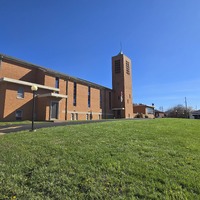 Wide view of St. Lucas church building and lawn.